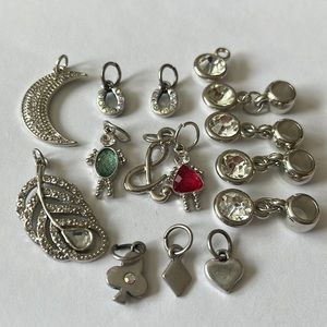Groups of charms:  child, &, moon, leaf, horseshoes, diamond, club, and heart